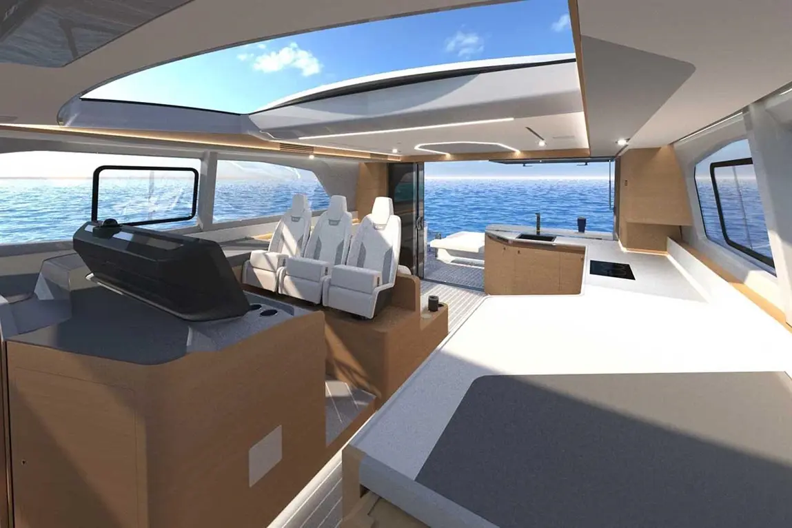 Modern yacht interior featuring white reclining seats, a helm, and a view of the ocean under a bright blue sky.